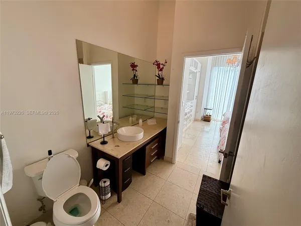 a bathroom with a toilet a sink and a mirror