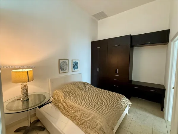 a bedroom with a bed and a table