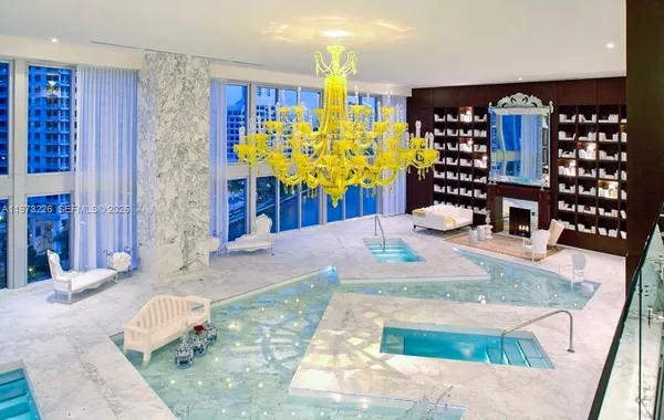 a view of spacious bedroom with a chandelier