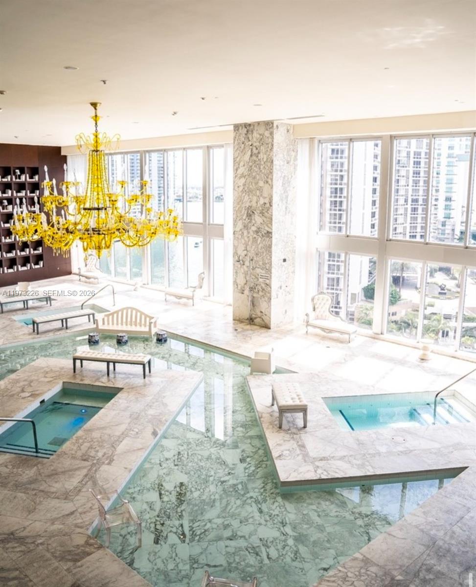 495 Brickell Avenue, Unit 1403 Miami, FL 33131 - Photo 40 of 48 a view of a living room and a floor to ceiling window and a kitchen