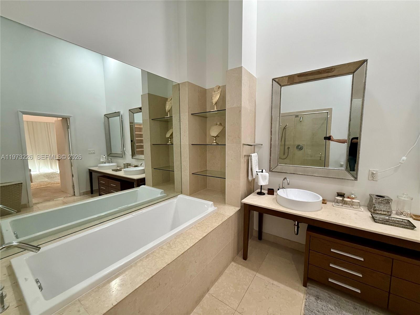 495 Brickell Avenue, Unit 1403 Miami, FL 33131 - Photo 4 of 48 a spacious bathroom with a double vanity sink tub and a mirror