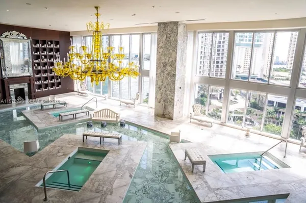 a view of swimming pool with outdoor seating and city view