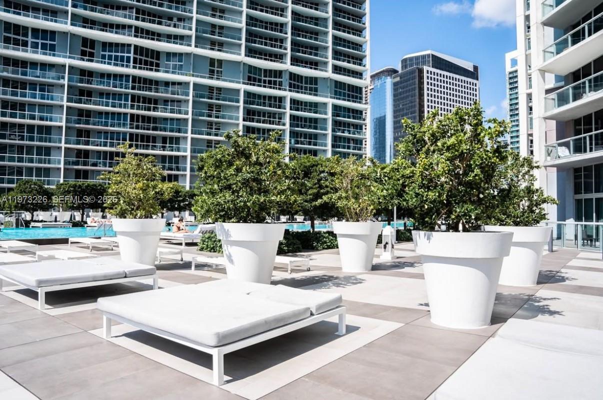 495 Brickell Avenue, Unit 1403 Miami, FL 33131 - Photo 43 of 48 a view of a patio with couches and a potted plant on a table