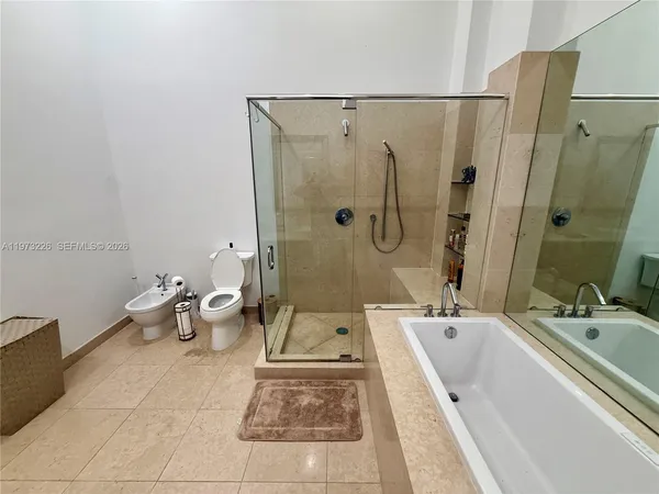 a bathroom with a tub sink and mirror
