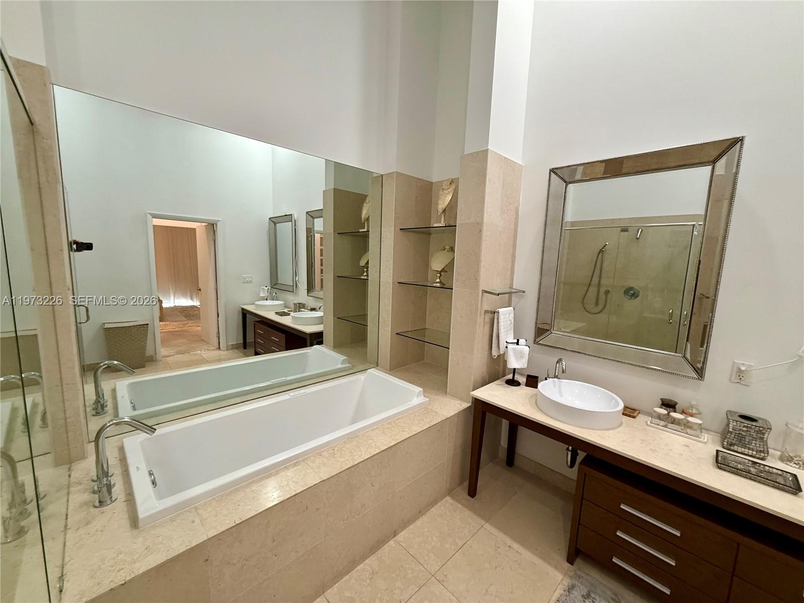 495 Brickell Avenue, Unit 1403 Miami, FL 33131 - Photo 8 of 48 a bathroom with a tub sink and mirror