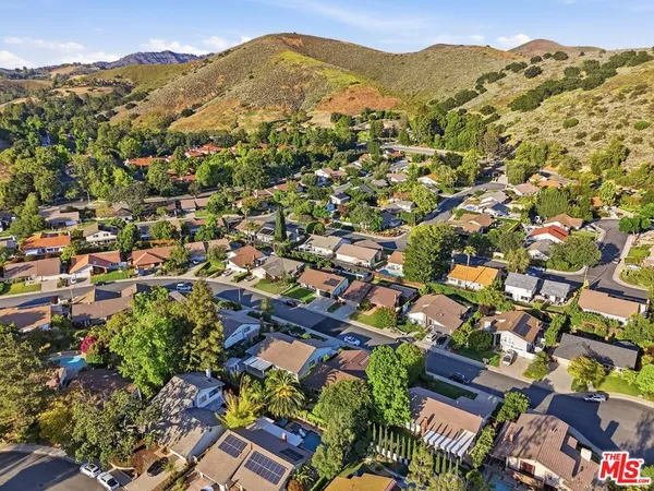 an aerial view of residential houses with outdoor space