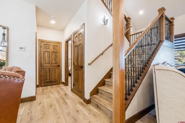 a view of entryway with wooden floor and stairs