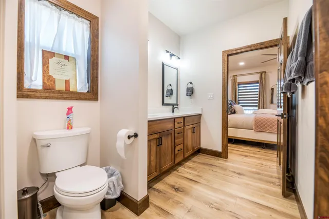 a en suite bathroom with a toilet a sink and a mirror