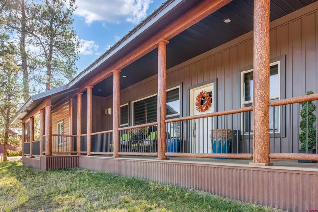 a view of a house with a yard and wooden fence