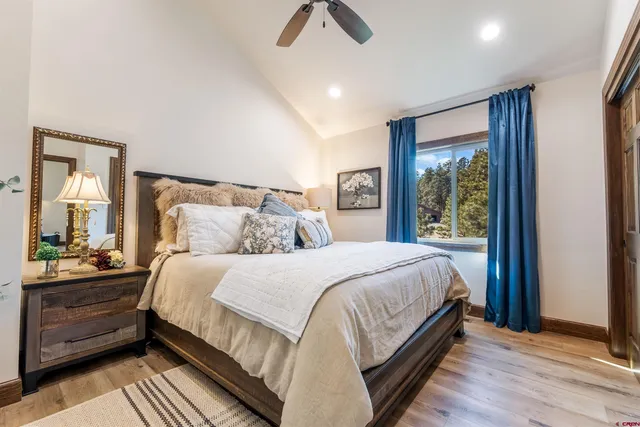 a bedroom with a bed and wooden floor