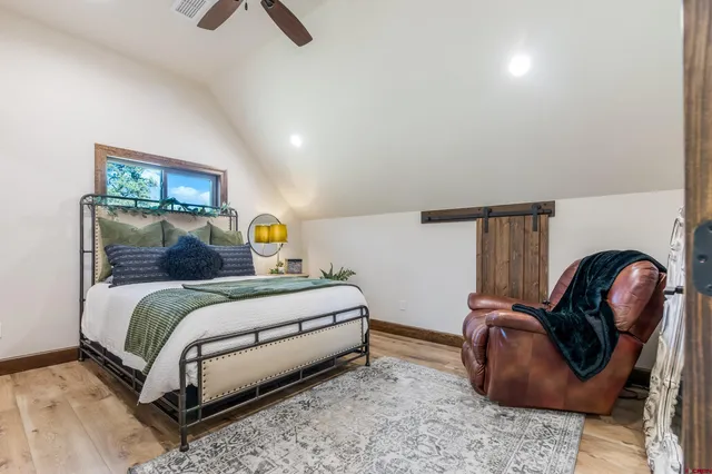 a bedroom with a bed chair and a dresser