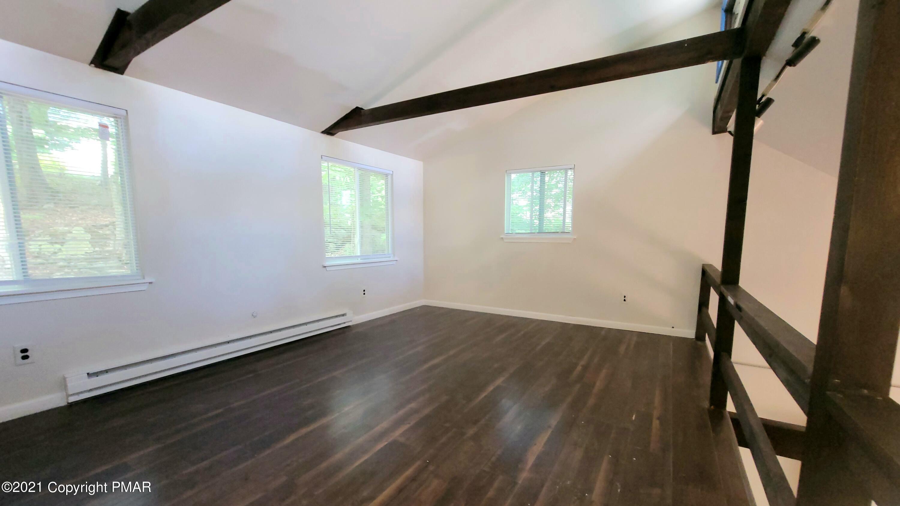 3153 Cherry Ridge Road Bushkill, PA 18324 - Photo 14 of 41 a view of an empty room with wooden floor and a window