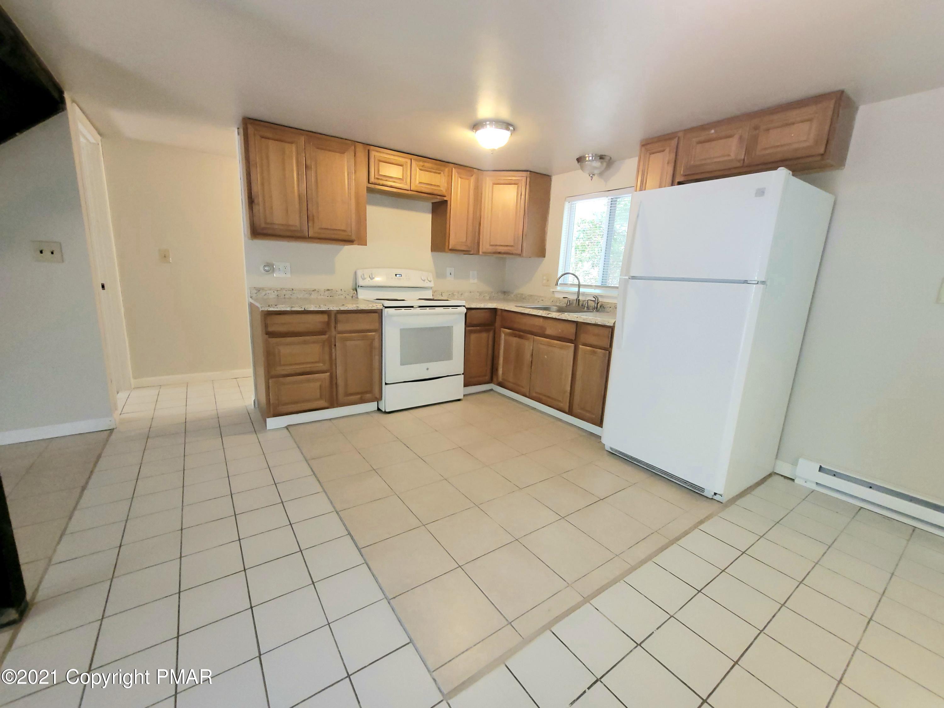 3153 Cherry Ridge Road Bushkill, PA 18324 - Photo 3 of 41 a kitchen with a refrigerator sink and cabinets