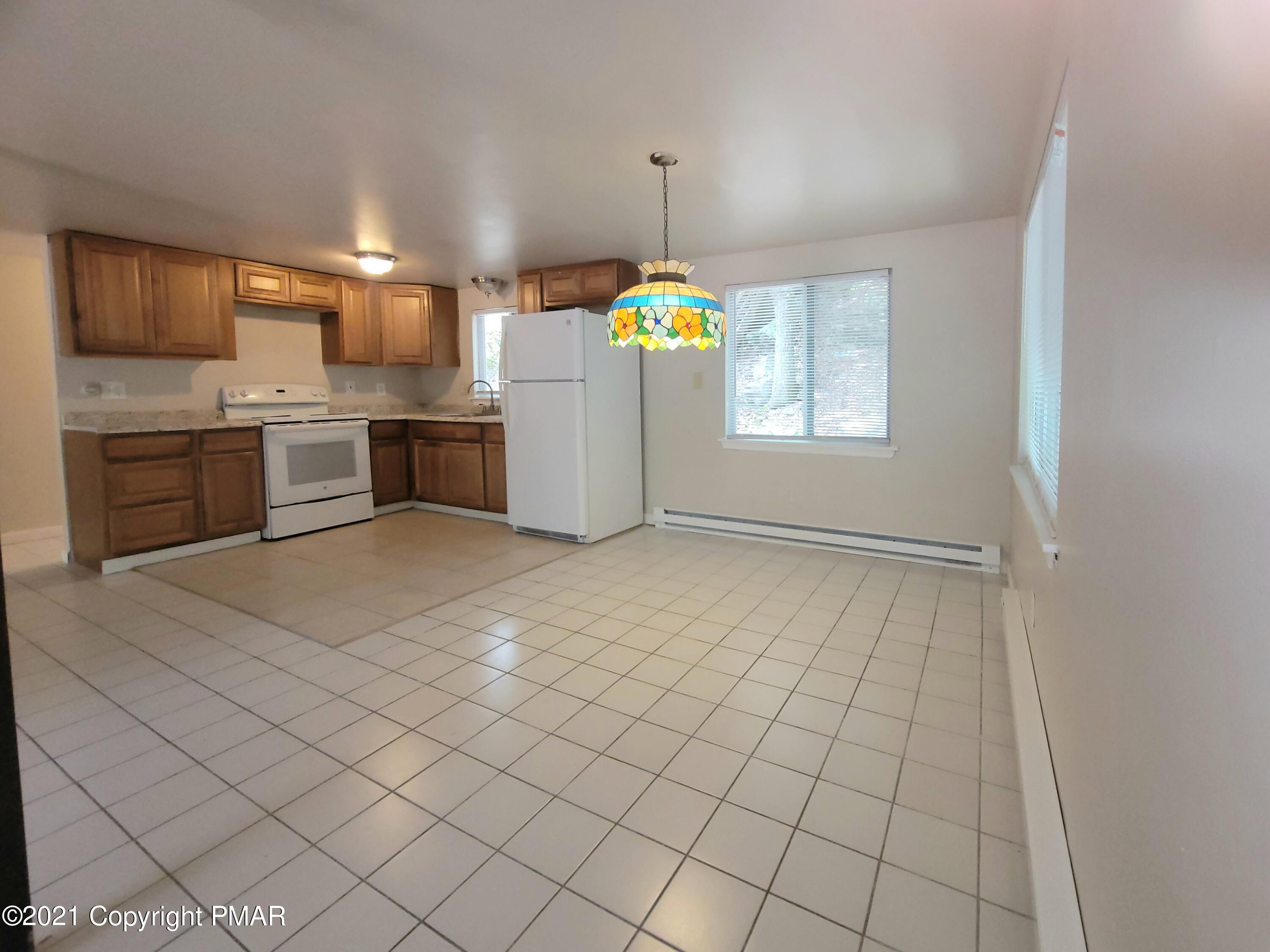3153 Cherry Ridge Road Bushkill, PA 18324 - Photo 4 of 41 a kitchen with stainless steel appliances a refrigerator and microwave