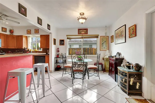 a dining room with furniture and a flat screen tv