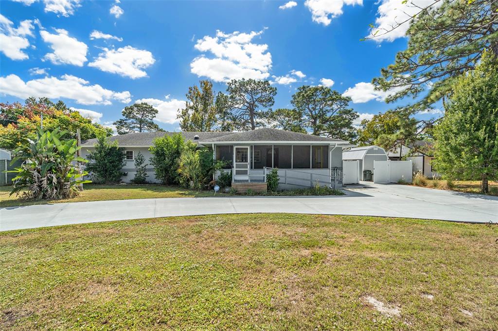 9738 Ray Street Hudson, FL 34669 - Photo 1 of 30 a view of a house with swimming pool and a yard