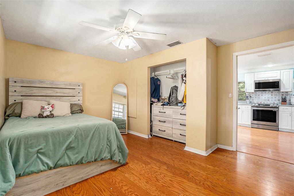 9738 Ray Street Hudson, FL 34669 - Photo 18 of 30 a bedroom with a bed and a view of kitchen