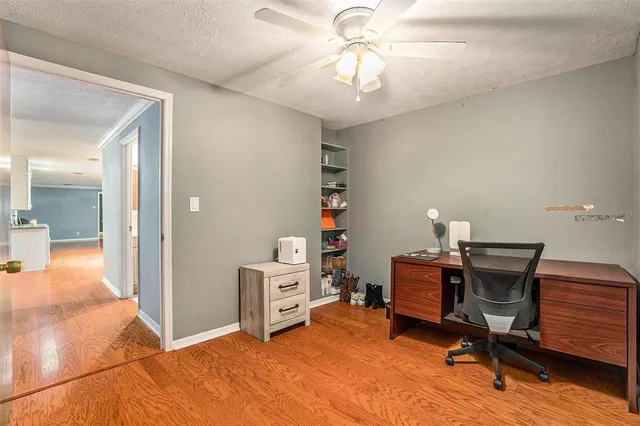 a view of a workspace with furniture and a bedroom