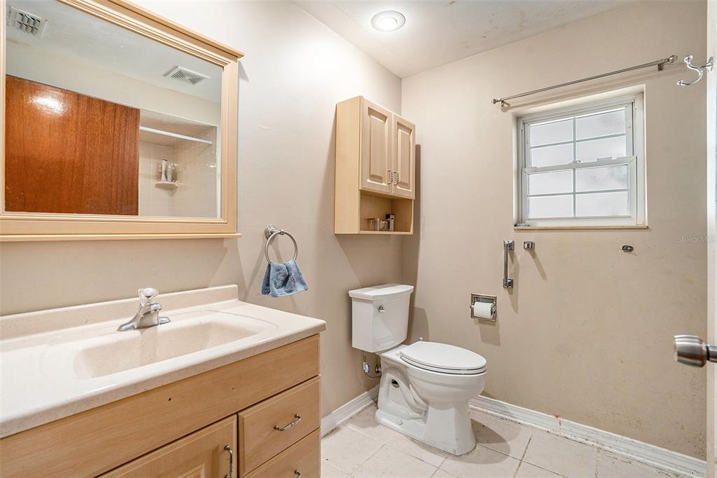 9738 Ray Street Hudson, FL 34669 - Photo 21 of 30 a bathroom with a toilet sink and mirror