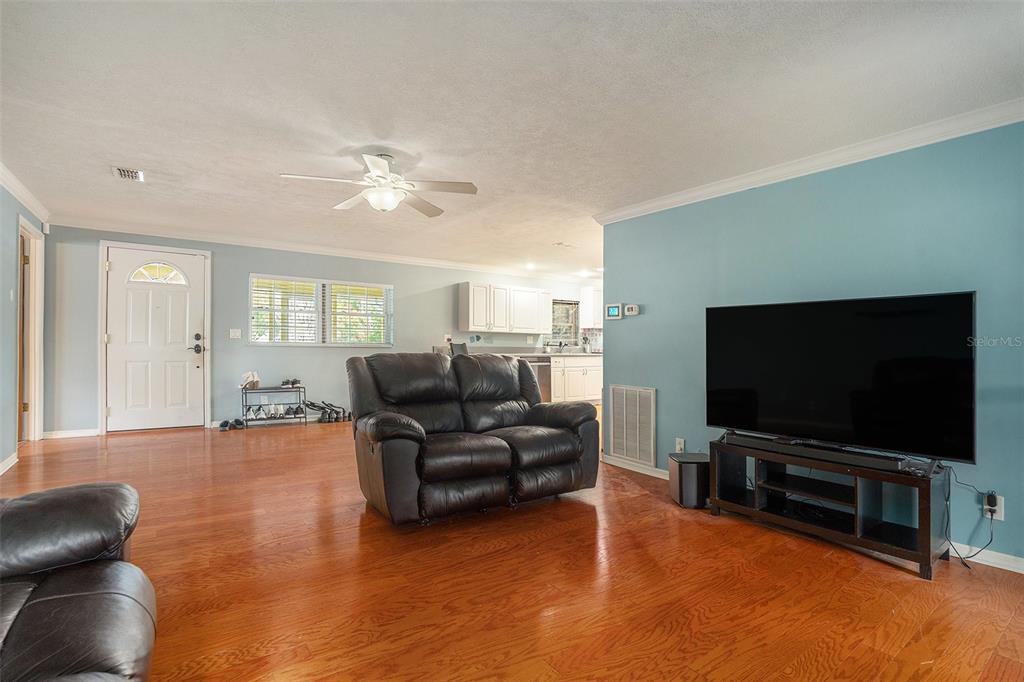 9738 Ray Street Hudson, FL 34669 - Photo 6 of 30 a living room with furniture and a flat screen tv