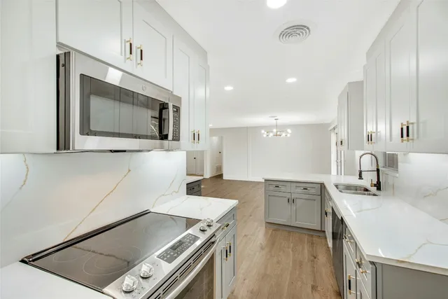 a kitchen with a sink stove and microwave