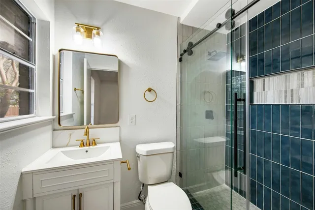 a bathroom with a sink toilet and shower