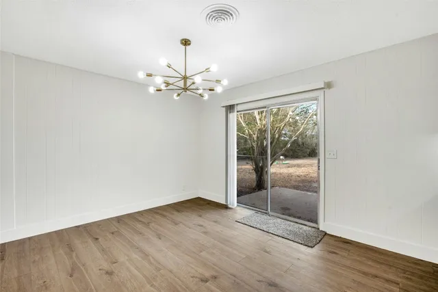a view of a livingroom with a hardwood floor and a ceiling fan
