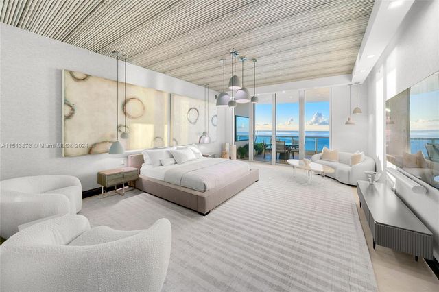 a bedroom with a bed couch and window