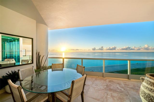 a view of a patio with a table and chairs