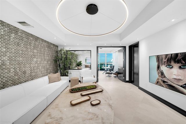 a living room with furniture gym equipment and a large window