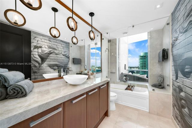 a large living room with fireplace furniture and a large window