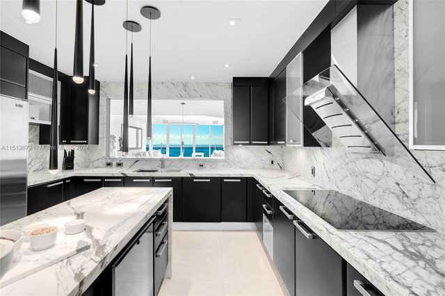 a kitchen with stainless steel appliances granite countertop a sink and a stove