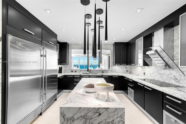 a large kitchen with kitchen island granite countertop a sink and counter space