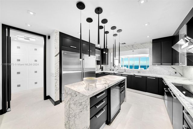 a kitchen with a sink a stove and cabinets