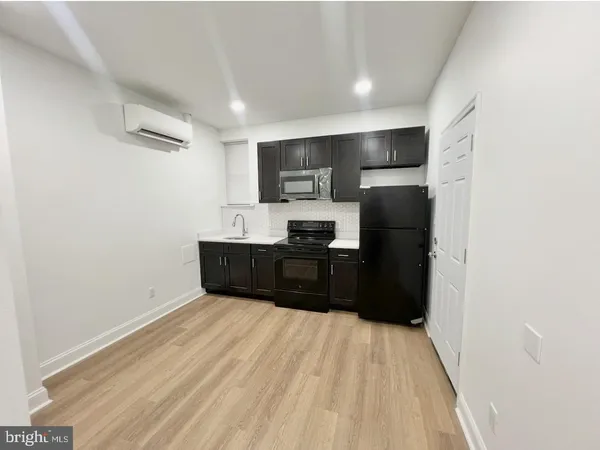 a kitchen with a refrigerator and a sink