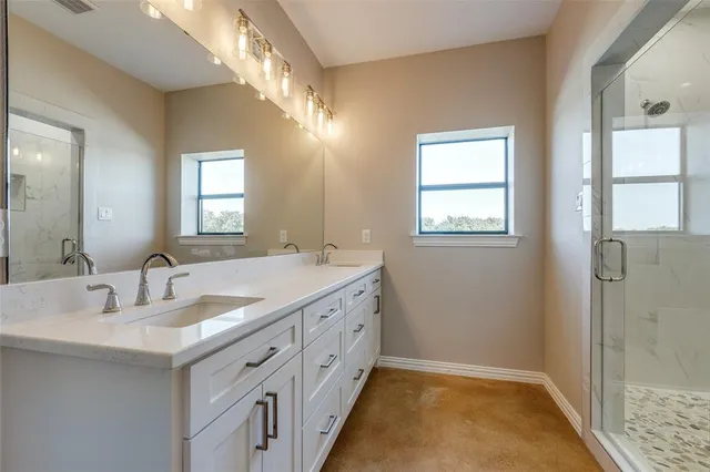 a bathroom with a double vanity sink and a mirror