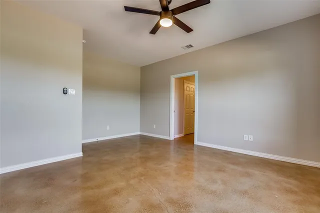 an empty room with closet and windows
