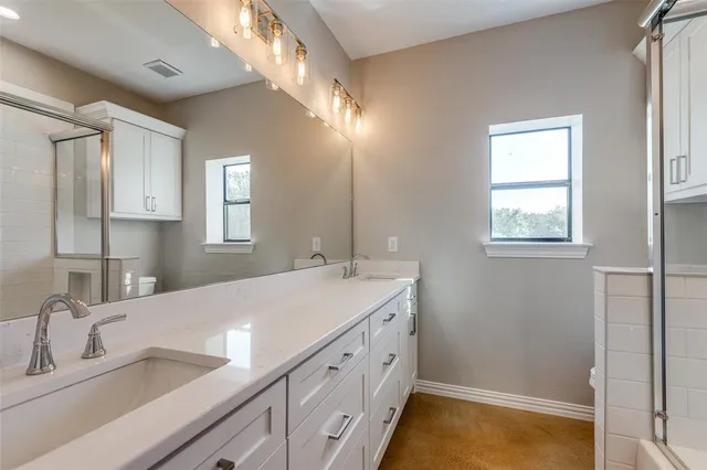 a bathroom with a tub sink and mirror