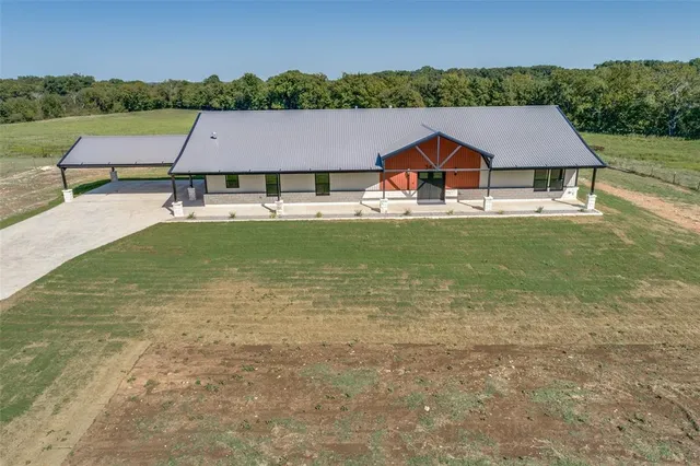 an aerial view of a house with pool