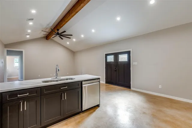 a bathroom with a granite countertop sink a mirror and vanity