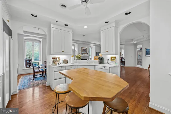 a large kitchen with a table and chairs