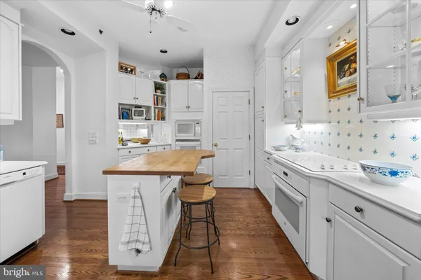 a kitchen with stainless steel appliances kitchen island granite countertop a sink and cabinets