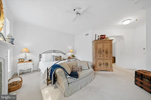 a bedroom with furniture and a chandelier