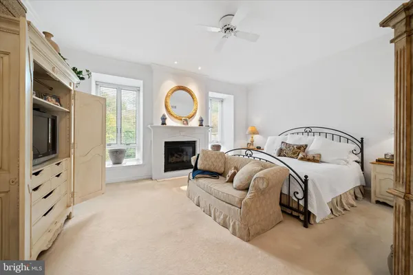 a spacious bedroom with a bed and a fireplace