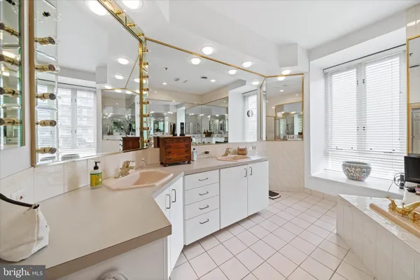 a large bathroom with a large tub sink and glass door