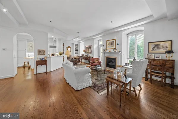 a living room with fireplace furniture and a wooden floor