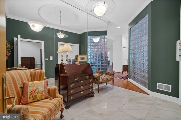 a living room with furniture and a chandelier