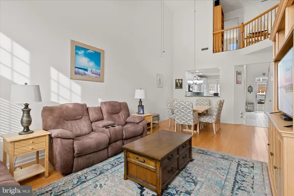a living room with furniture wooden floor and a rug