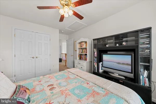 a bedroom with a bed and a television