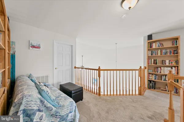 a bedroom with a bed and a book shelf
